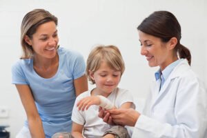 Child looking at his bandage in examination room